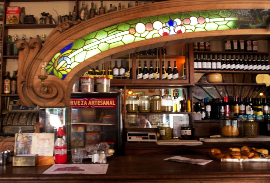 Barra de la barre du bar El Federal dans le quartier de San Telmo à Buenos Aires. Il y a un arc en bois de style art-nouveau et des vitraux.