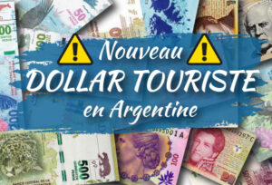 muchos billetes de pesos argentinos mezclados. sobre ellos hay un cartel que dice nouveau dollar touriste en argentine.